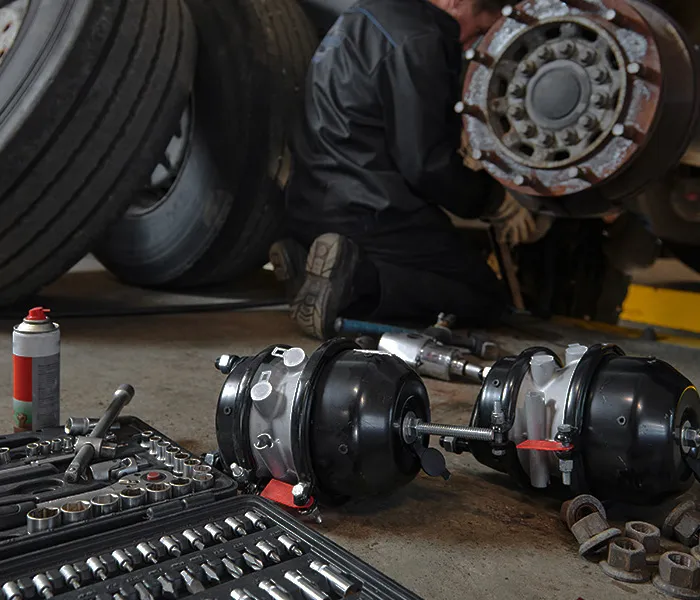 Motor trader working on a vehicle at a premises