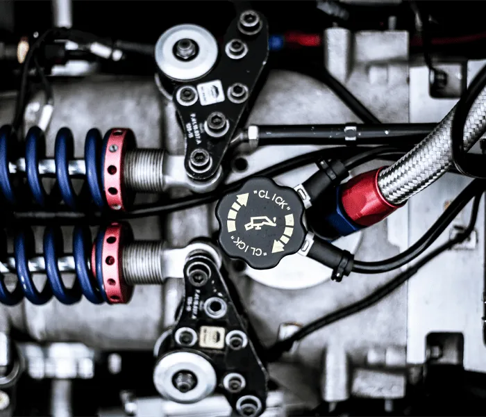 Close-up view of intricate machinery with springs, wires, and a central dial labeled 