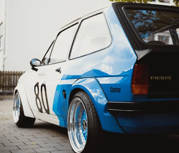 A classic blue and white car with the number 80, labeled 